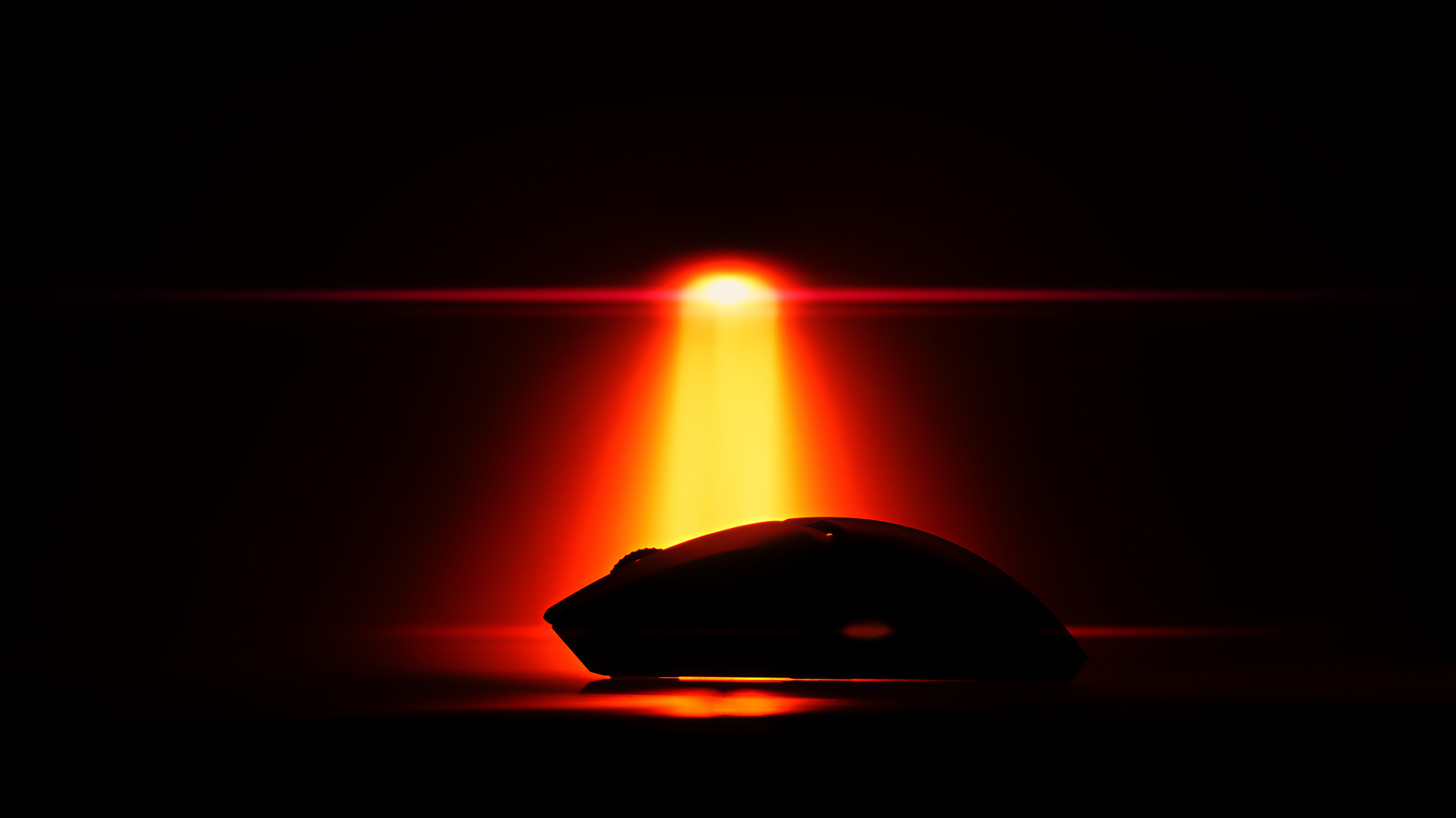 Red light beam falling off smoothly into black behind a mouse, recorded in 16-bit