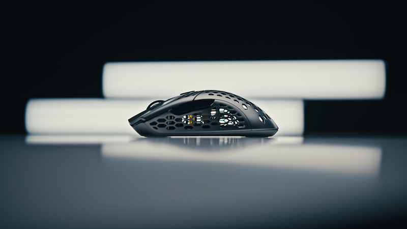Open-frame gaming mouse rim-lit between light bars, shot by Hypix Films