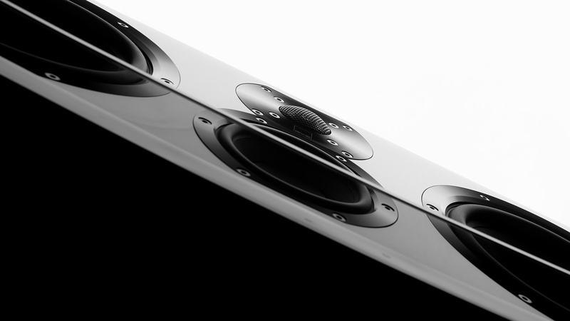 Speaker drivers in a glossy black and white panel shot on a steep diagonal