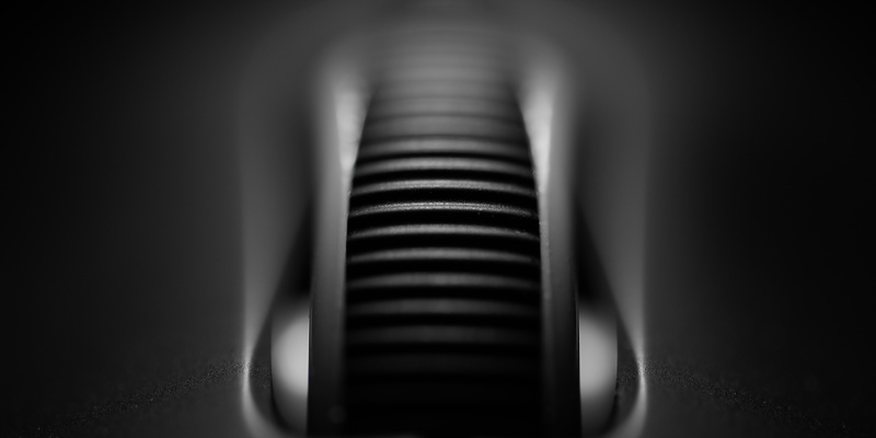 Monochrome macro of a ribbed mouse scroll wheel